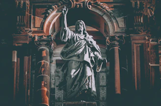 man in robe statue in cathedral