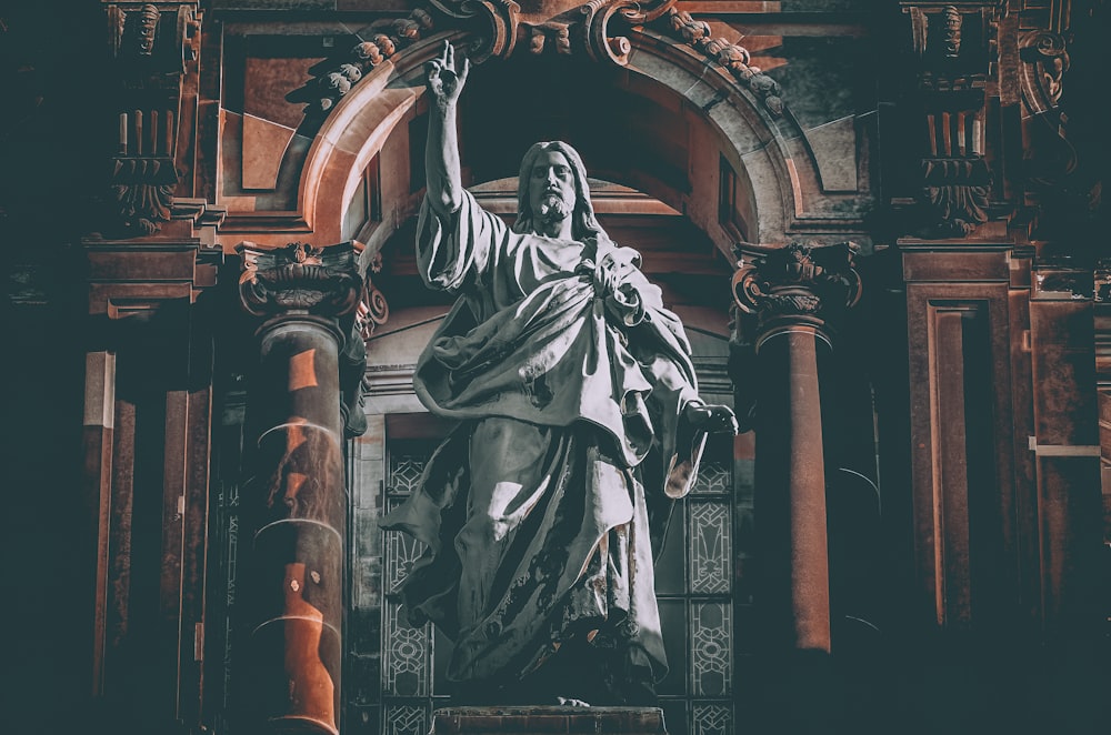 man in robe statue in cathedral