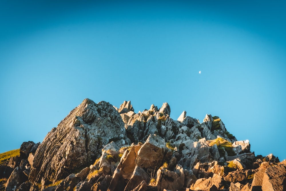 brown rocky mountain under blue sky during daytime