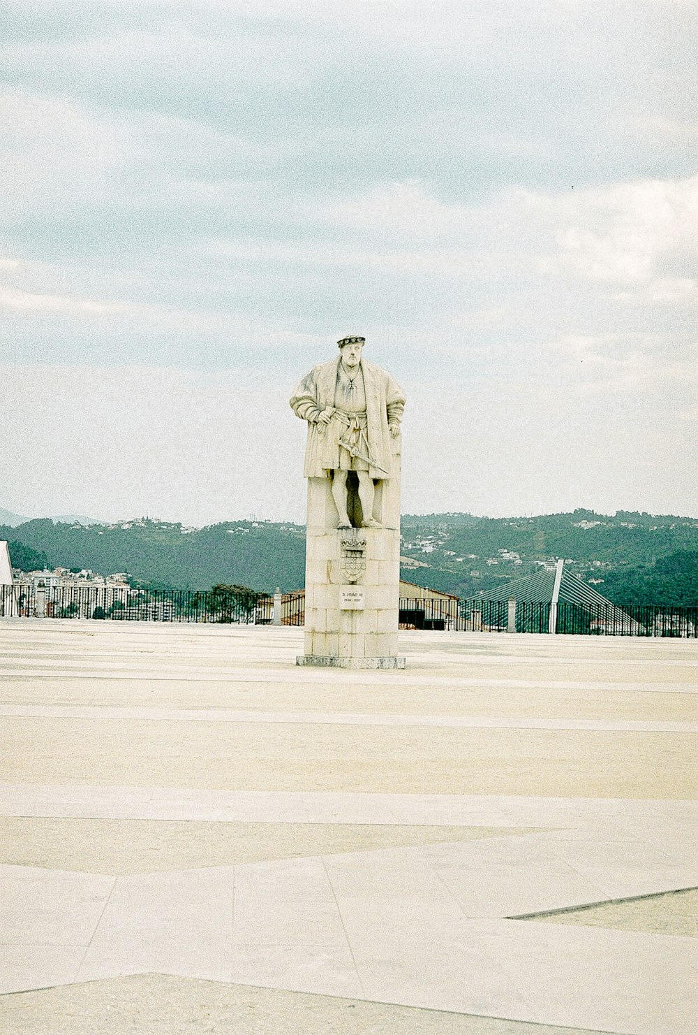 brown concrete statue on white field during daytime