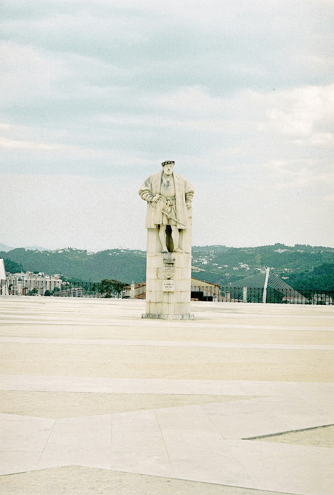 brown concrete statue on white field during daytime