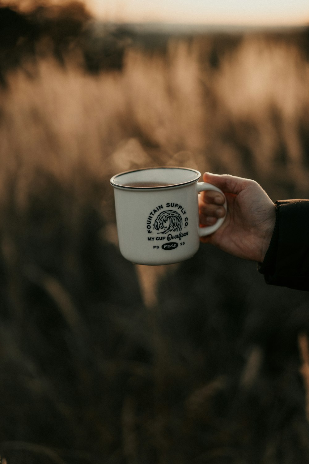 white and black ceramic mug