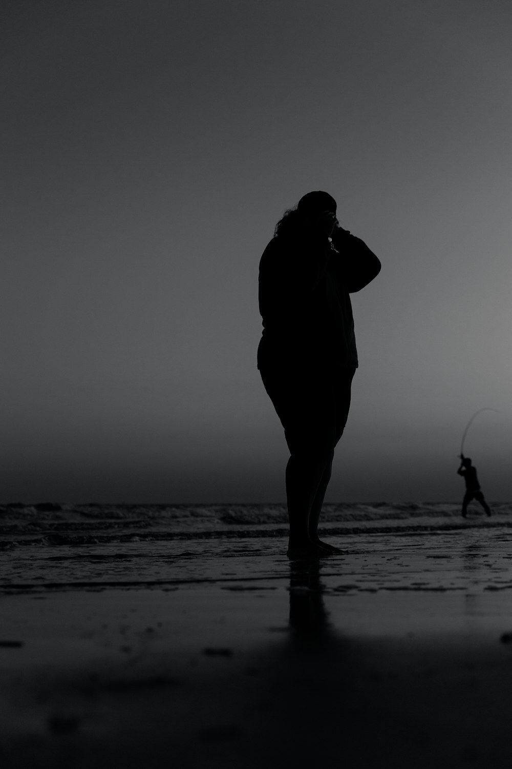 silhouette of man and woman kissing on beach during sunset