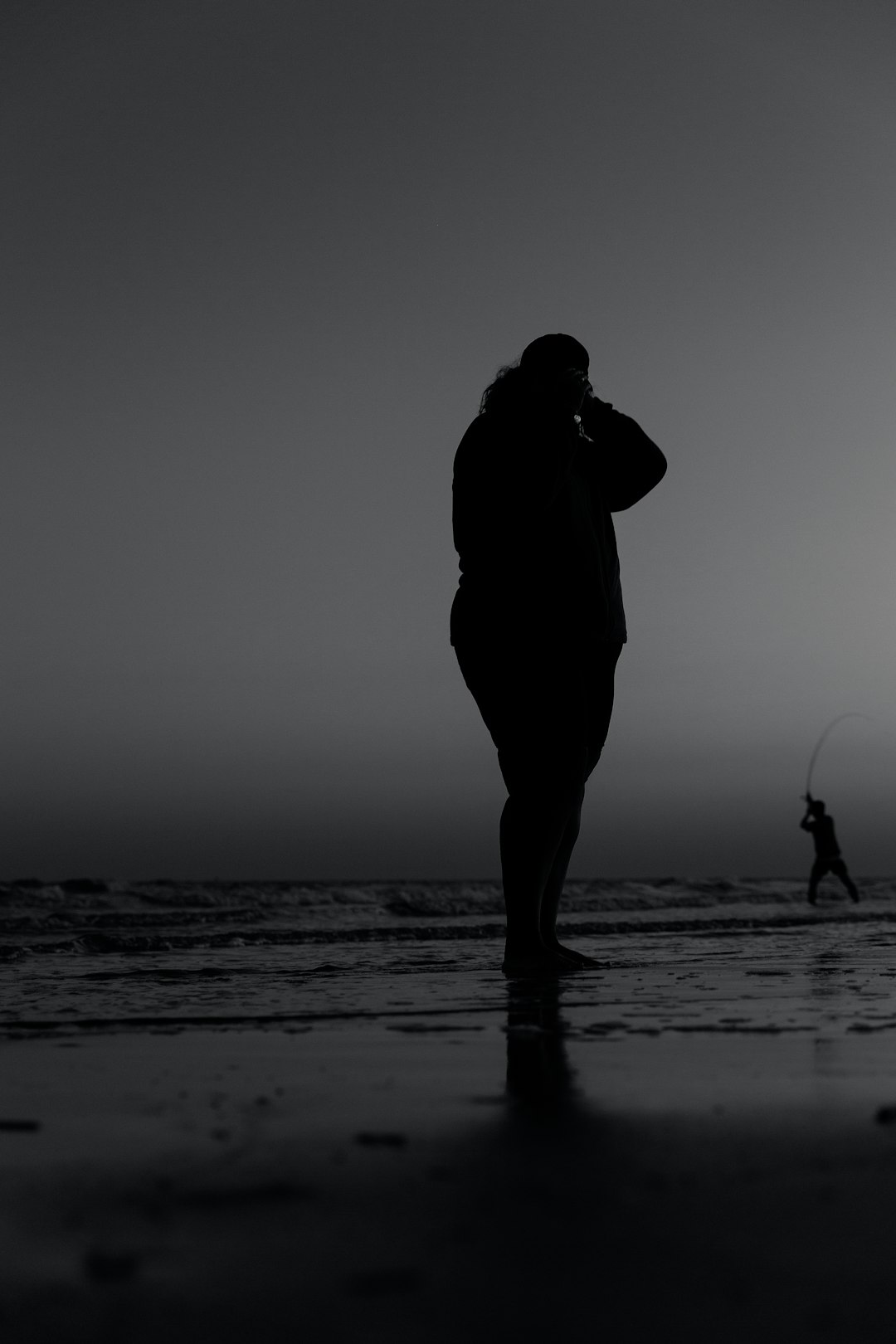 silhouette of man and woman kissing on beach during sunset