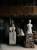 white ceramic statue on brown wooden table