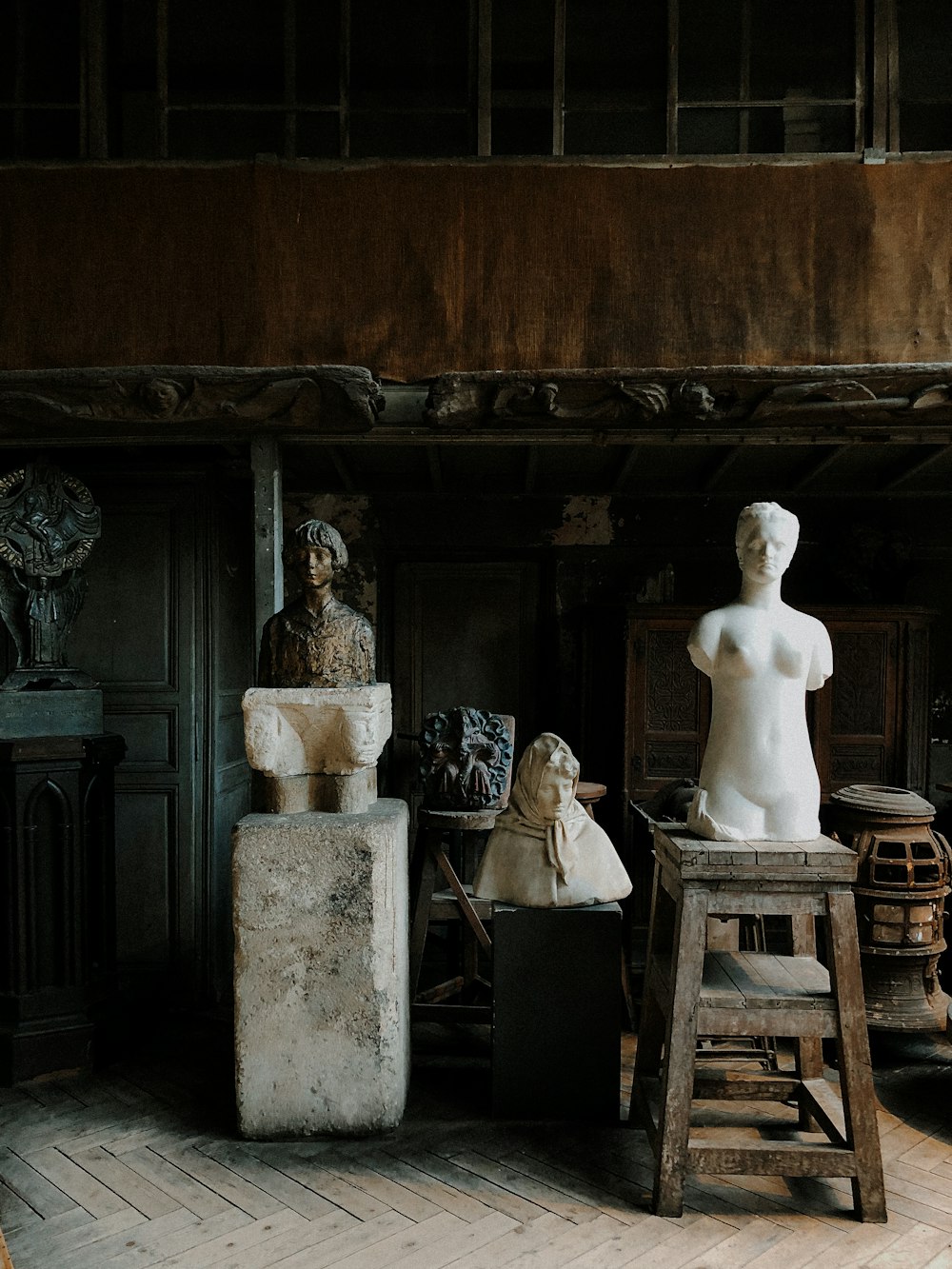 white ceramic statue on brown wooden table