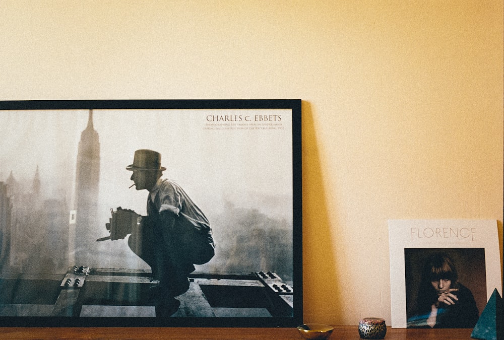 black flat screen tv turned on showing man in black jacket