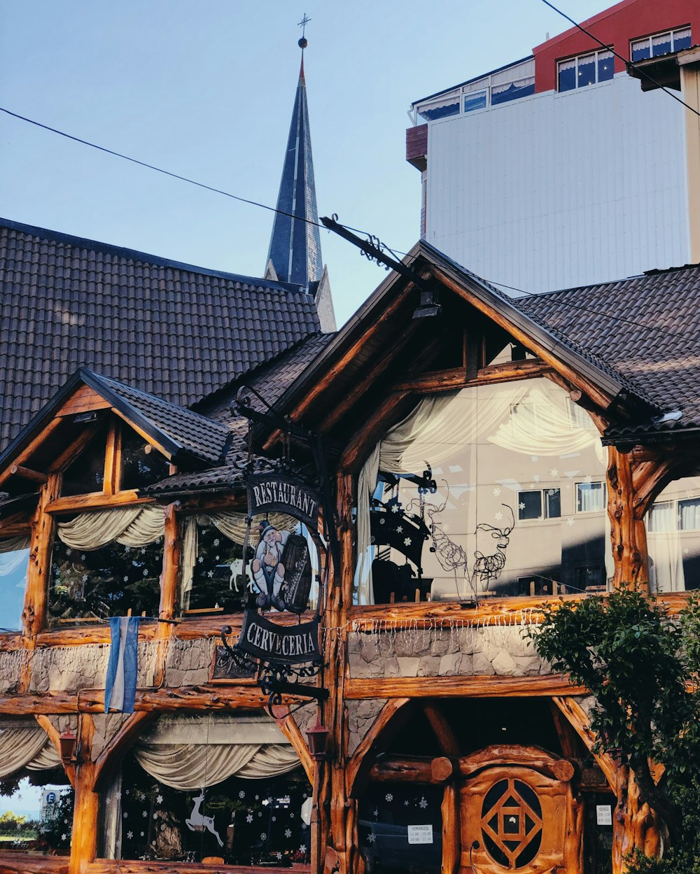 brown wooden house with black metal gate