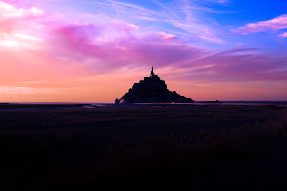 silhouette of building during sunset