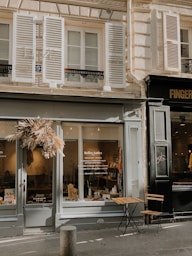 brown wooden table and chairs near glass window