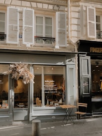 brown wooden table and chairs near glass window