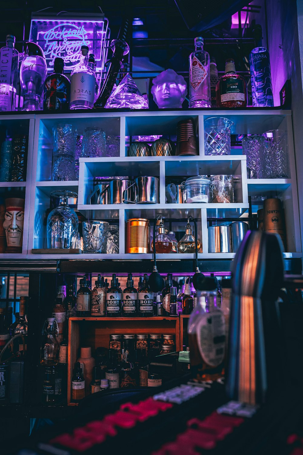 assorted bottles on brown wooden shelf