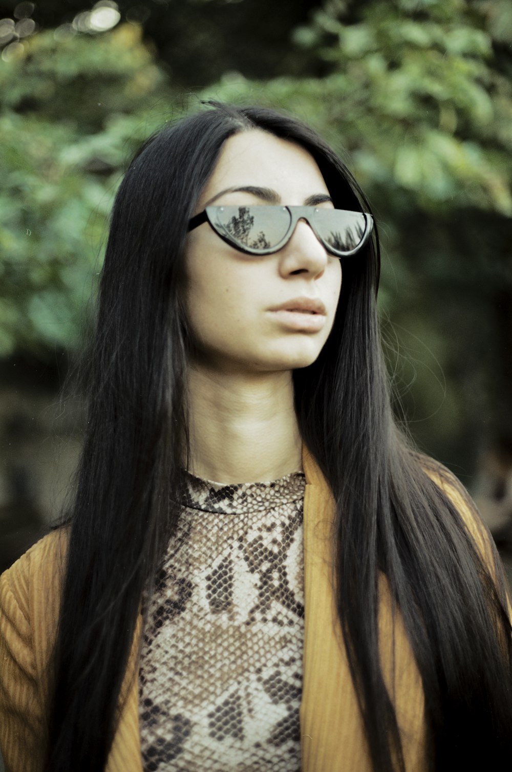 woman in black and brown leopard print shirt wearing black sunglasses