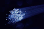 Image of fiber optic cables glowing with blue light against a dark background