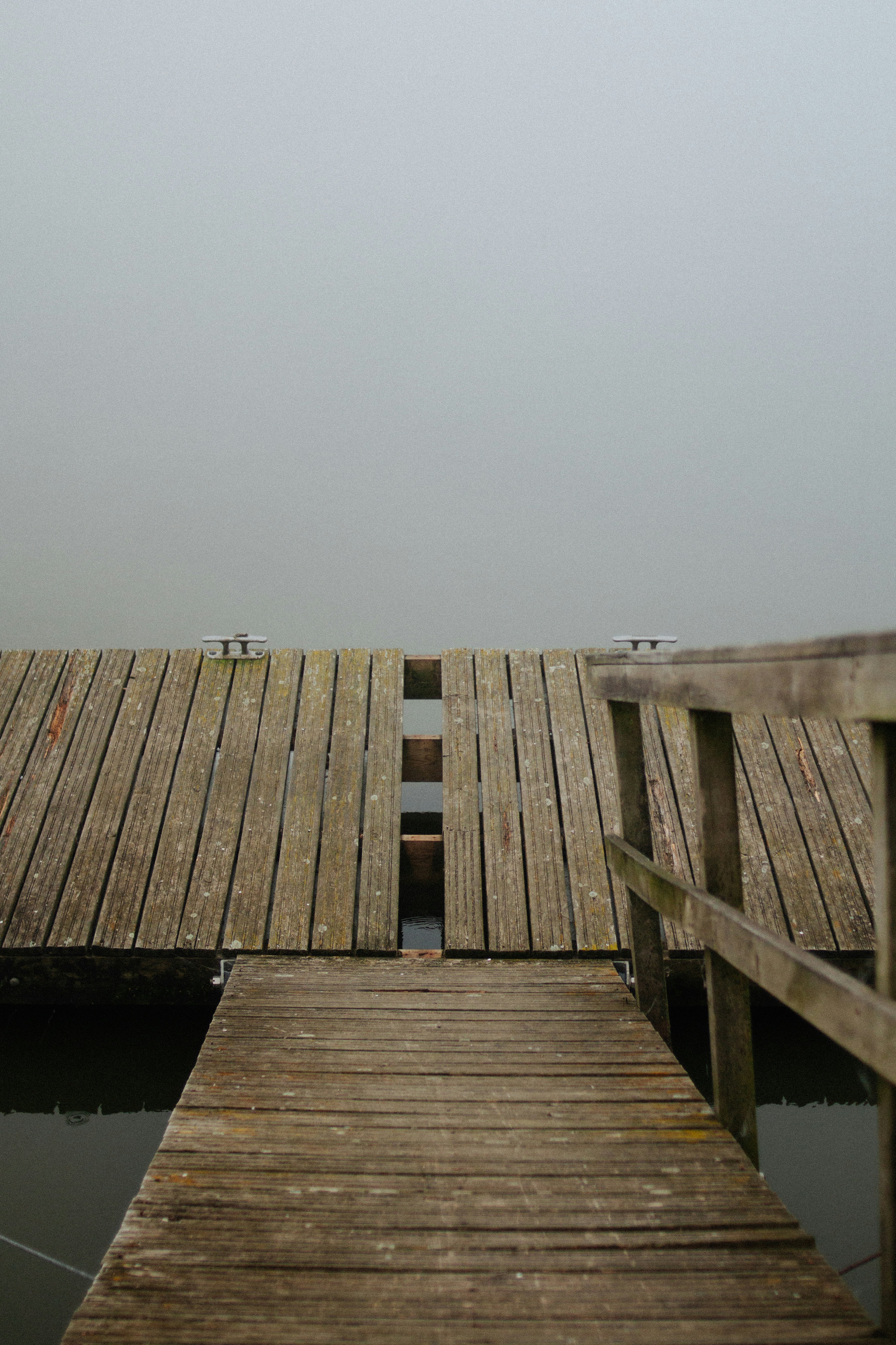 brown wooden dock on body of water