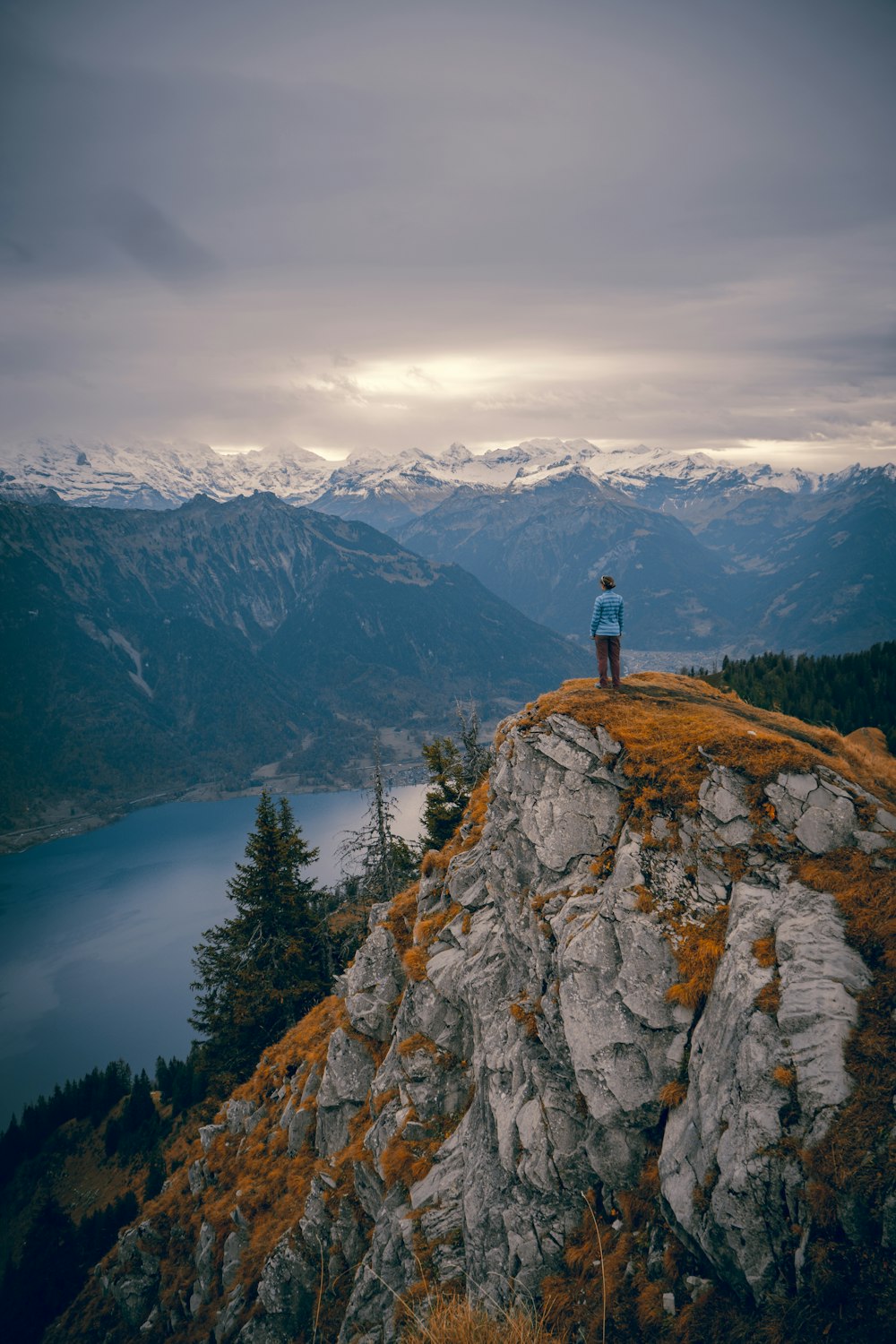 person standing on rock mountain during daytime