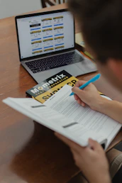 person writing on white paper