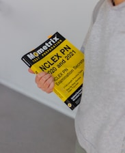 person holding yellow and black box