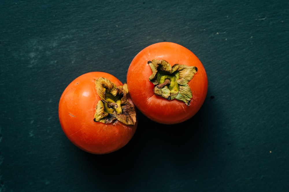 3 red tomato on black textile