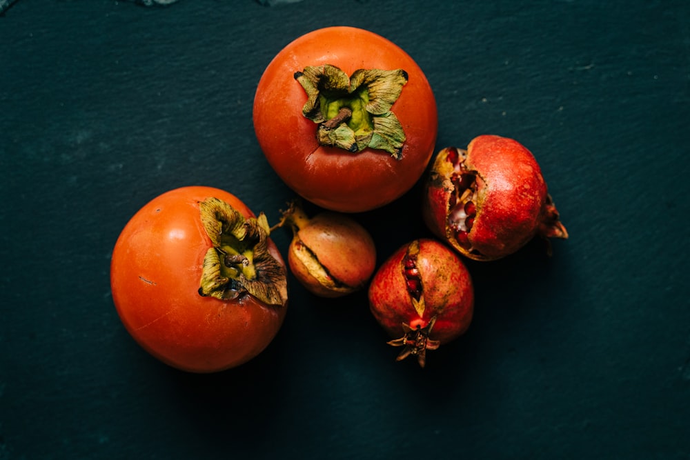 a group of tomatoes sitting on top of a table