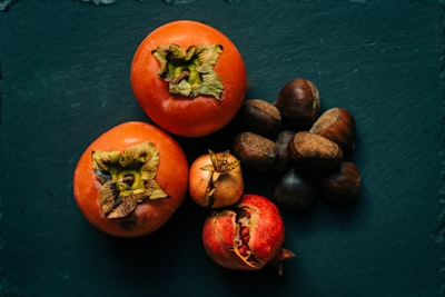 red round fruits on blue textile chestnuts teams background