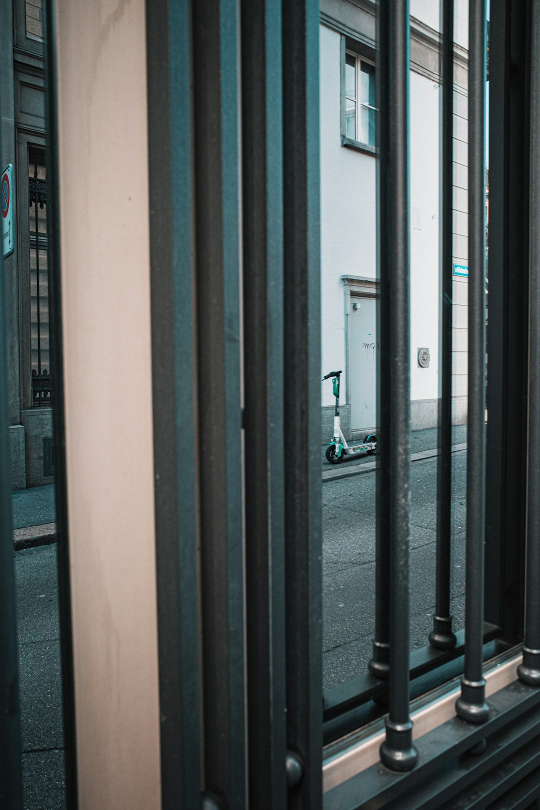 black metal gate near black car