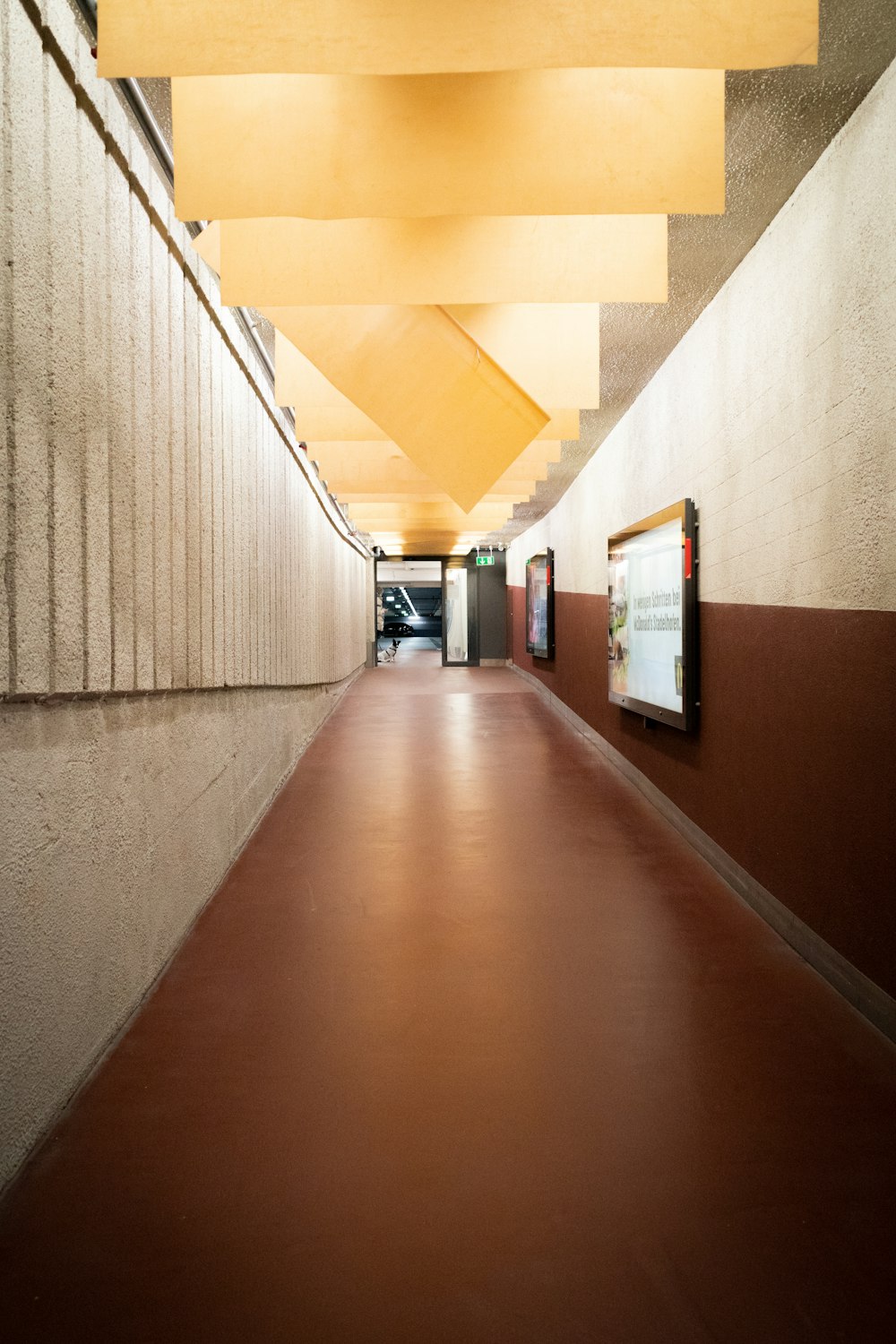 brown wooden hallway with white wall