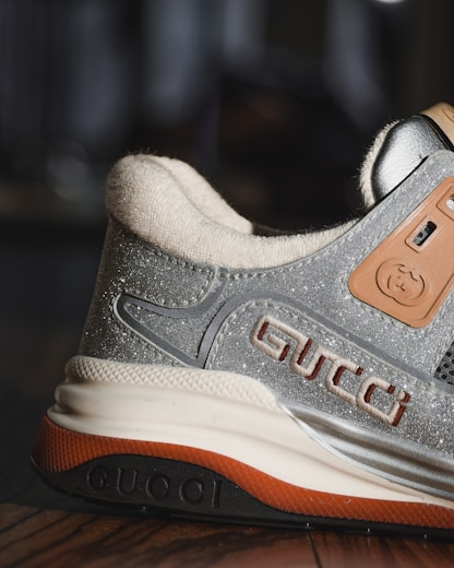 gray and orange nike athletic shoe