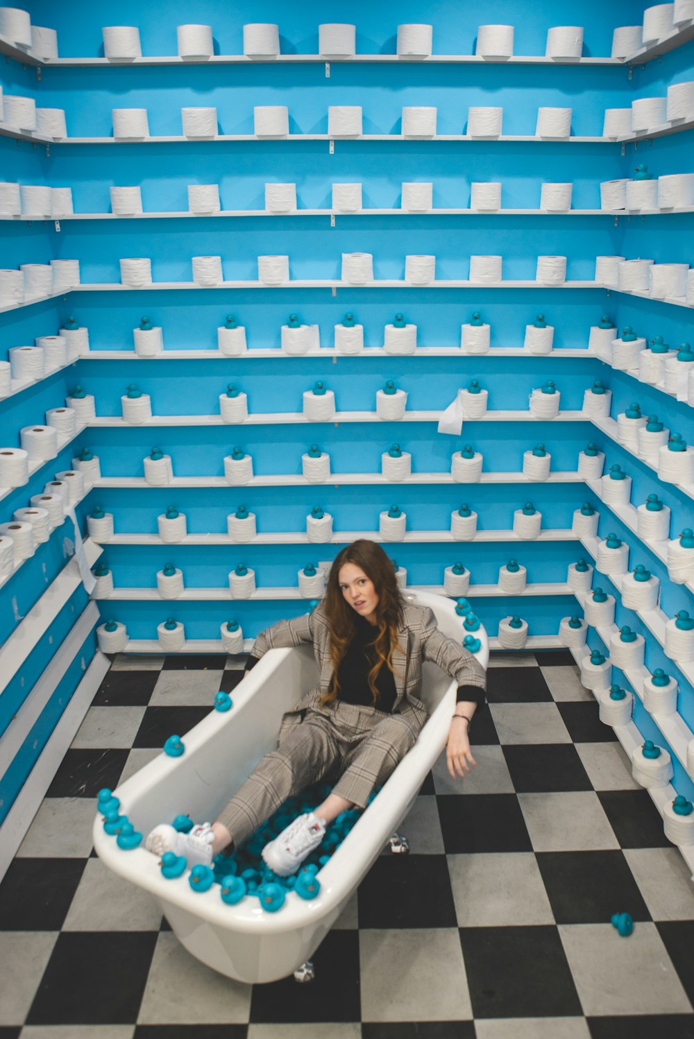 woman in black jacket sitting on white and blue staircase