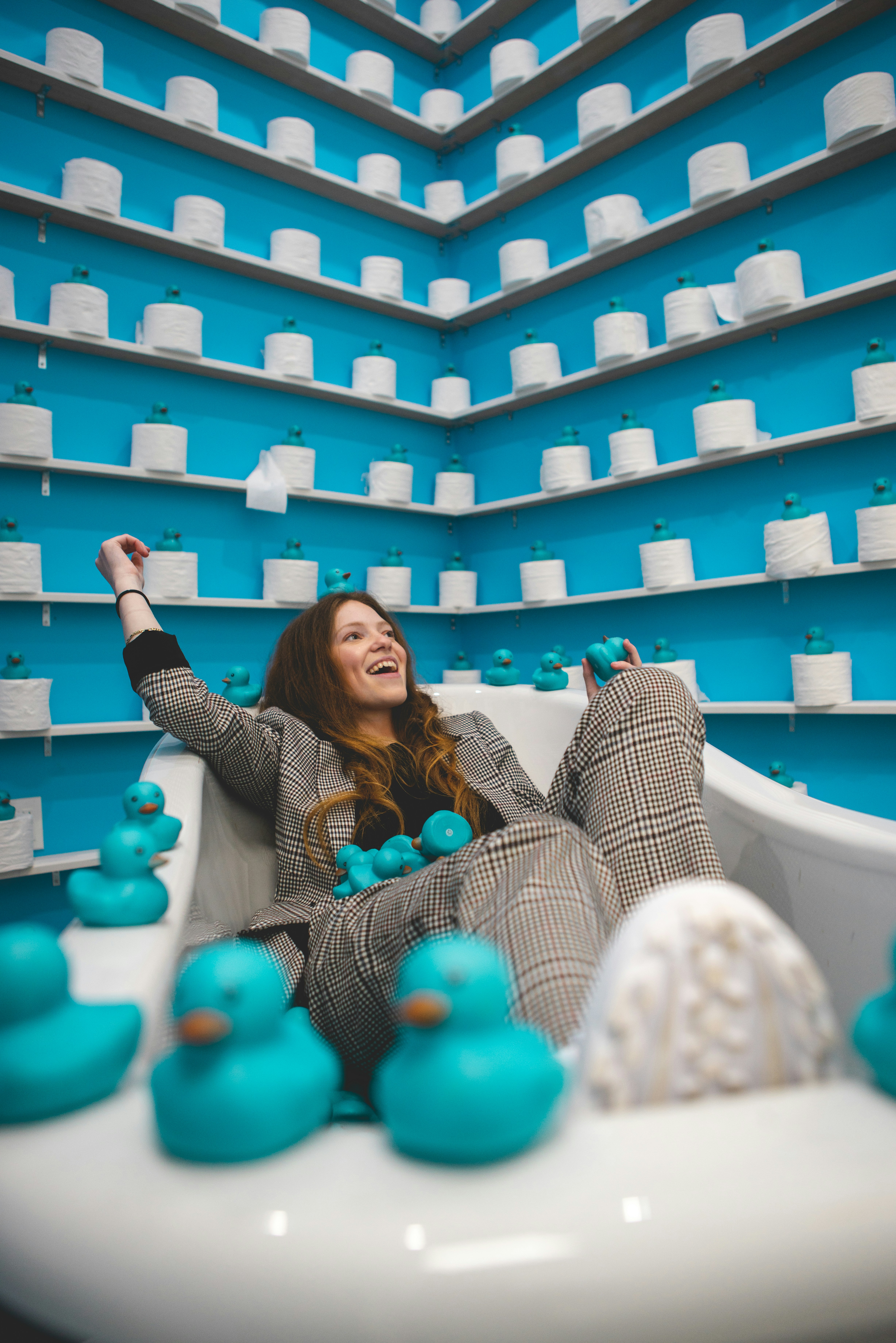 woman-in-black-and-white-long-sleeve-shirt-standing-beside-blue-and-white-balloons