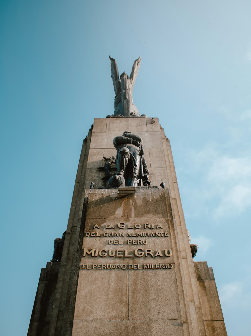 man riding horse statue under blue sky during daytime