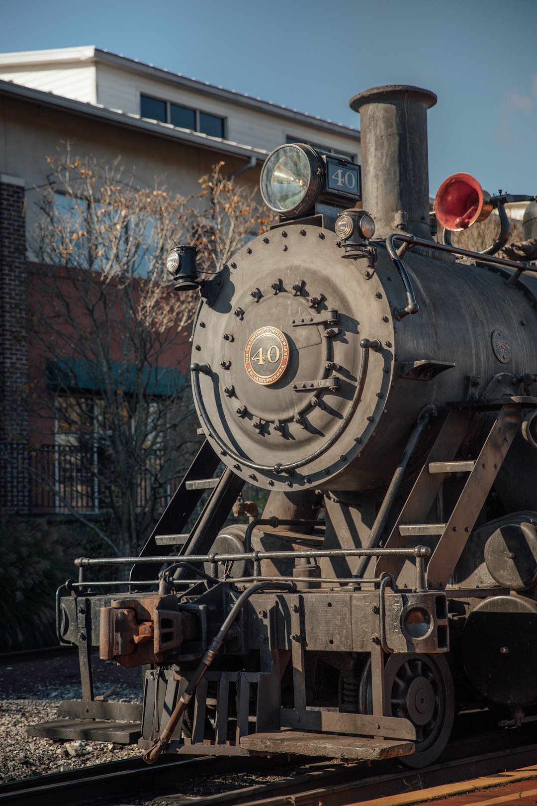 black and red train on rail tracks during daytime