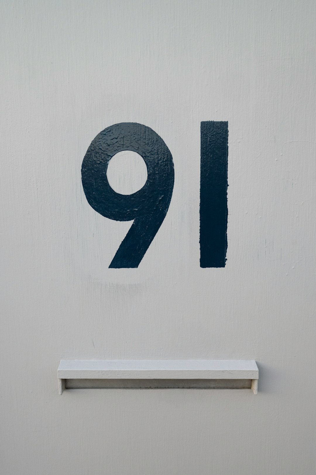 blue and white number 9 wall decor