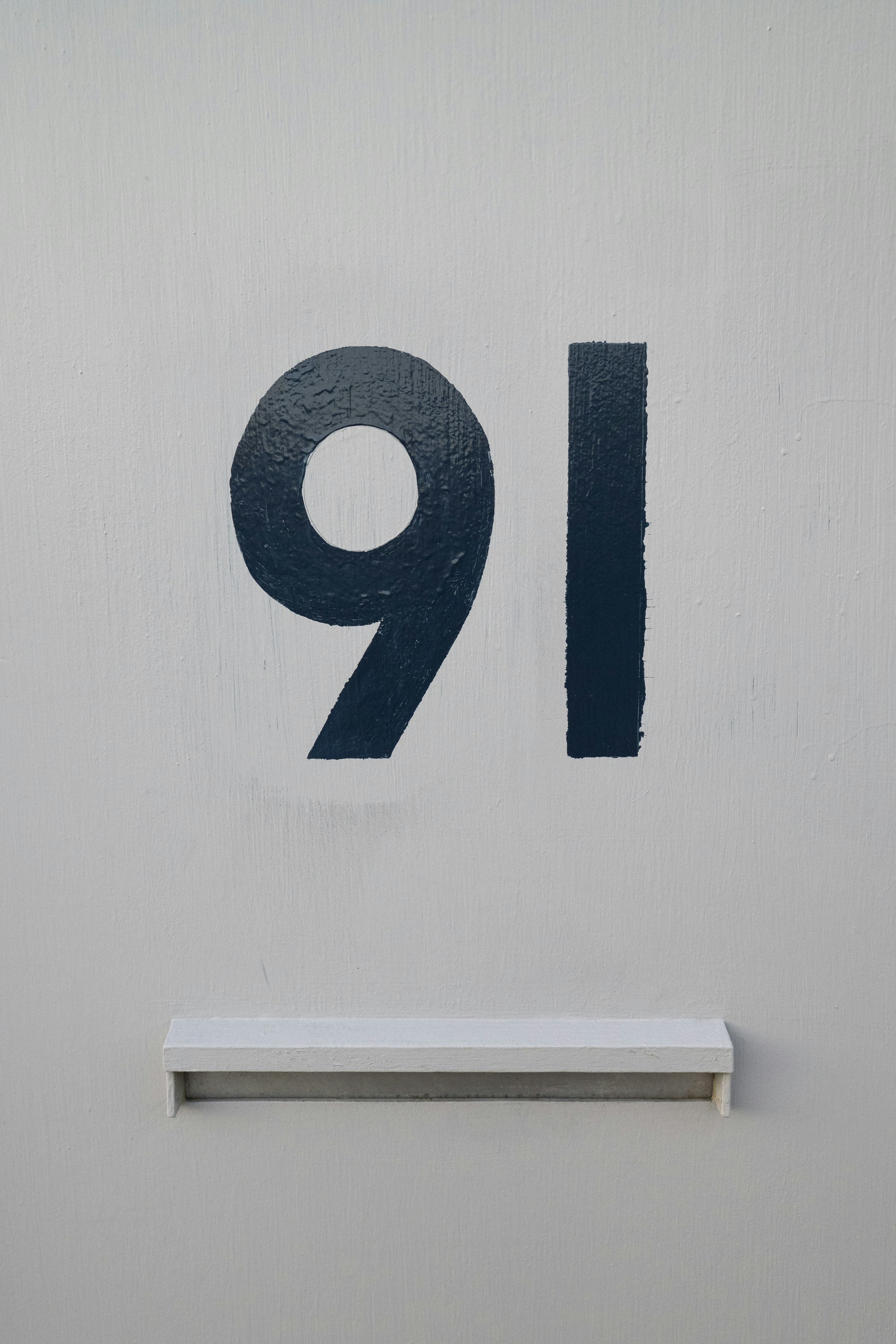 blue and white number 9 wall decor