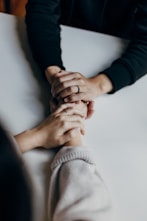 person in black long sleeve shirt holding babys feet