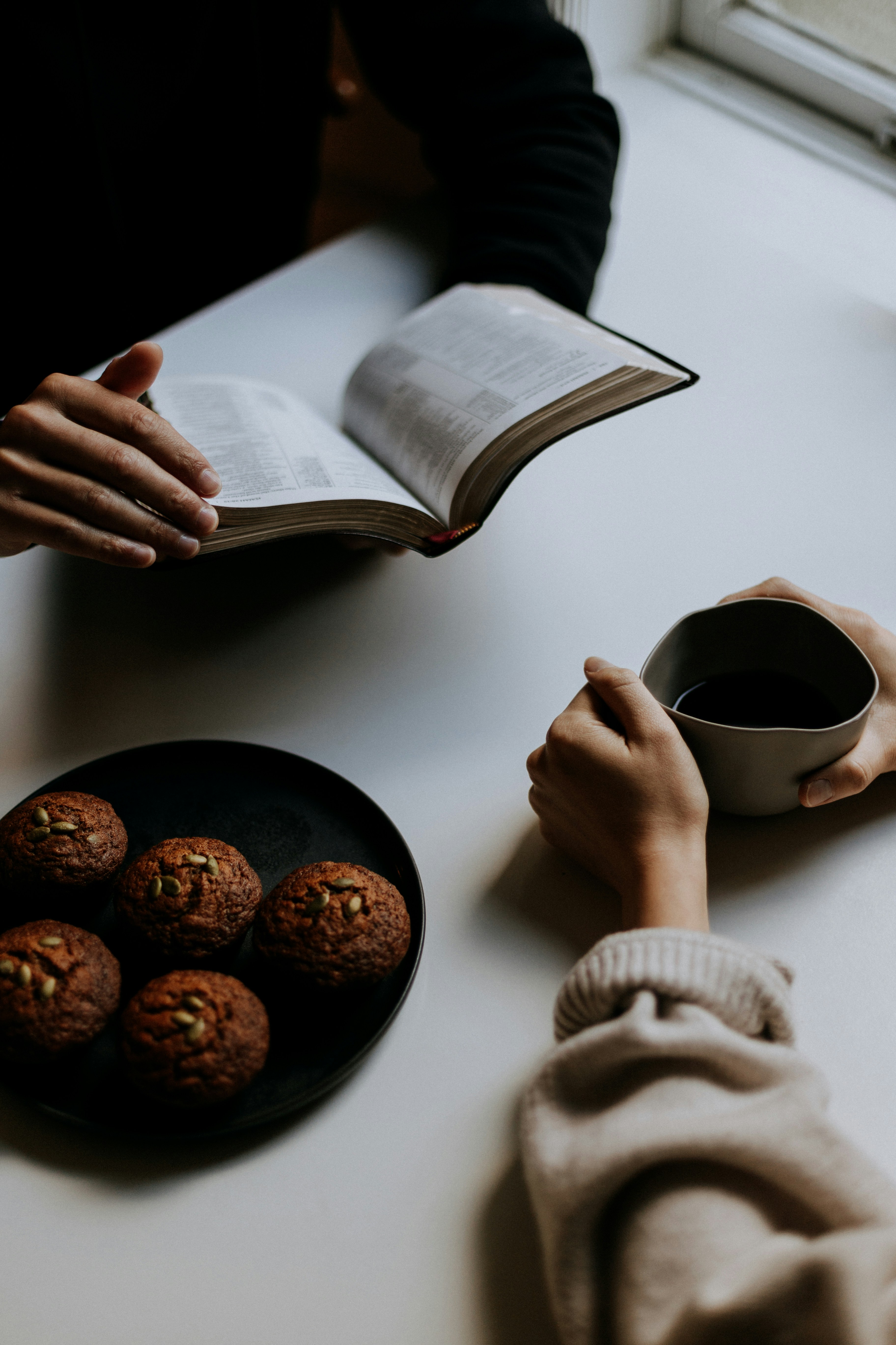 person-holding-white-ceramic-mug-with-coffee