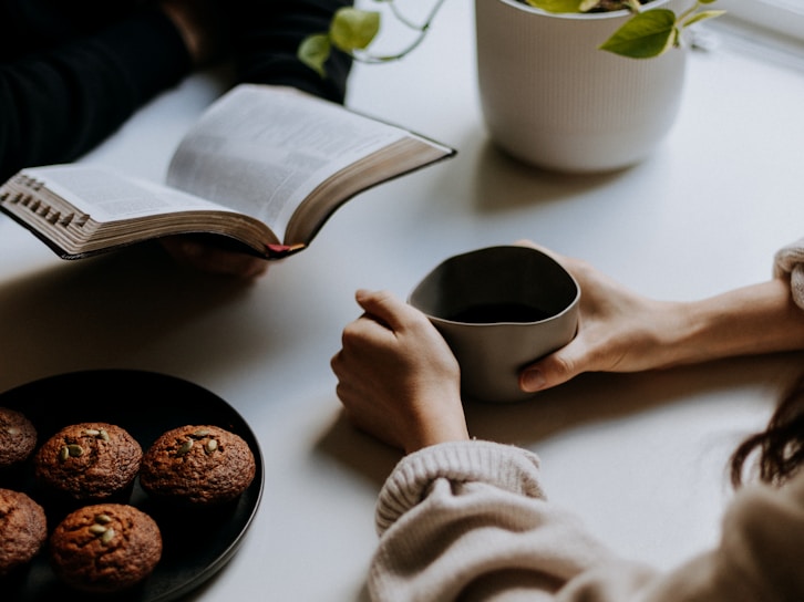 person holding white ceramic mug