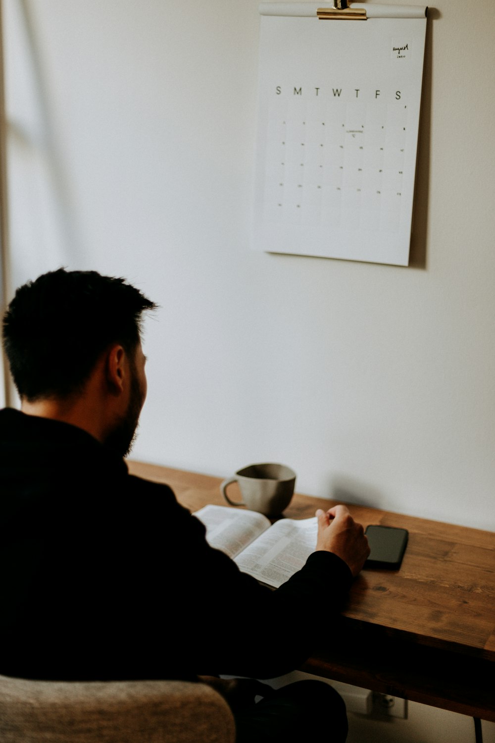 man in black long sleeve shirt sitting at the table