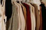 brown and white coat hanged on rack