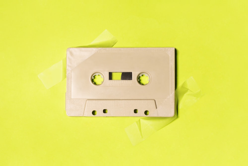 gray cassette tape on yellow surface