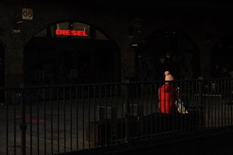 A close-up shot of a Lumina Apparel jacket draped over a sleek urban bench, sunlight casting soft shadows.