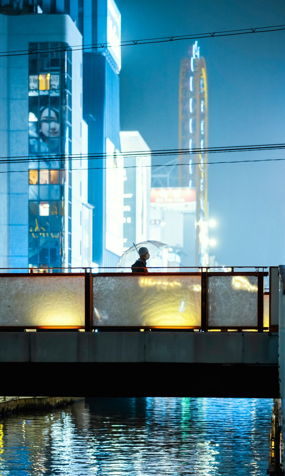 person in black jacket standing near glass window