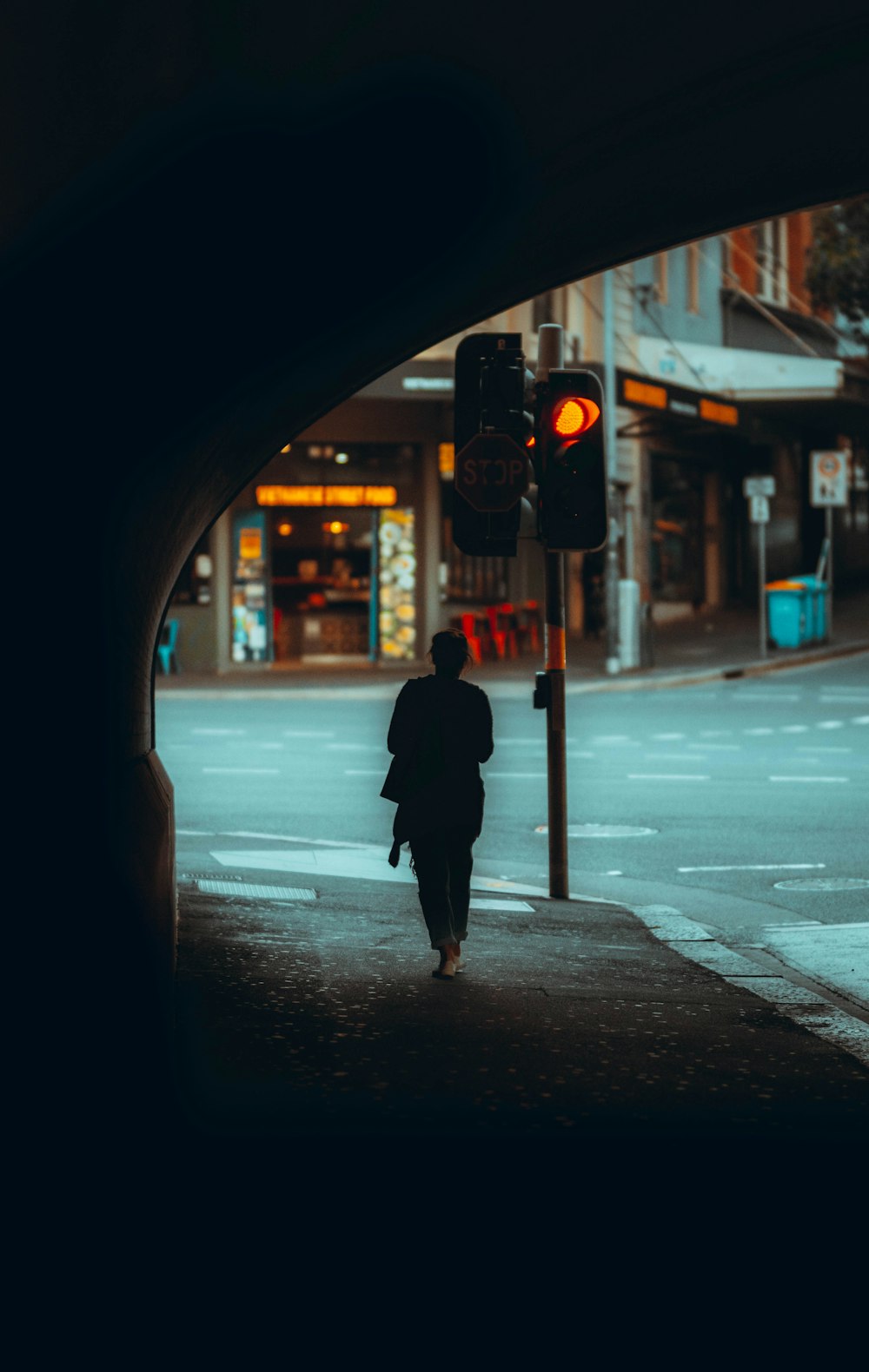 person in black coat standing on sidewalk during night time