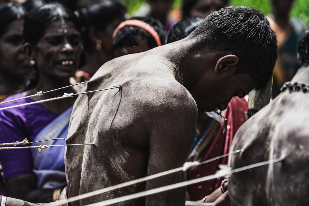 man in blue shirt holding white rope