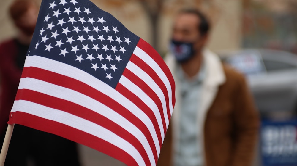 us a flag on mans shoulder