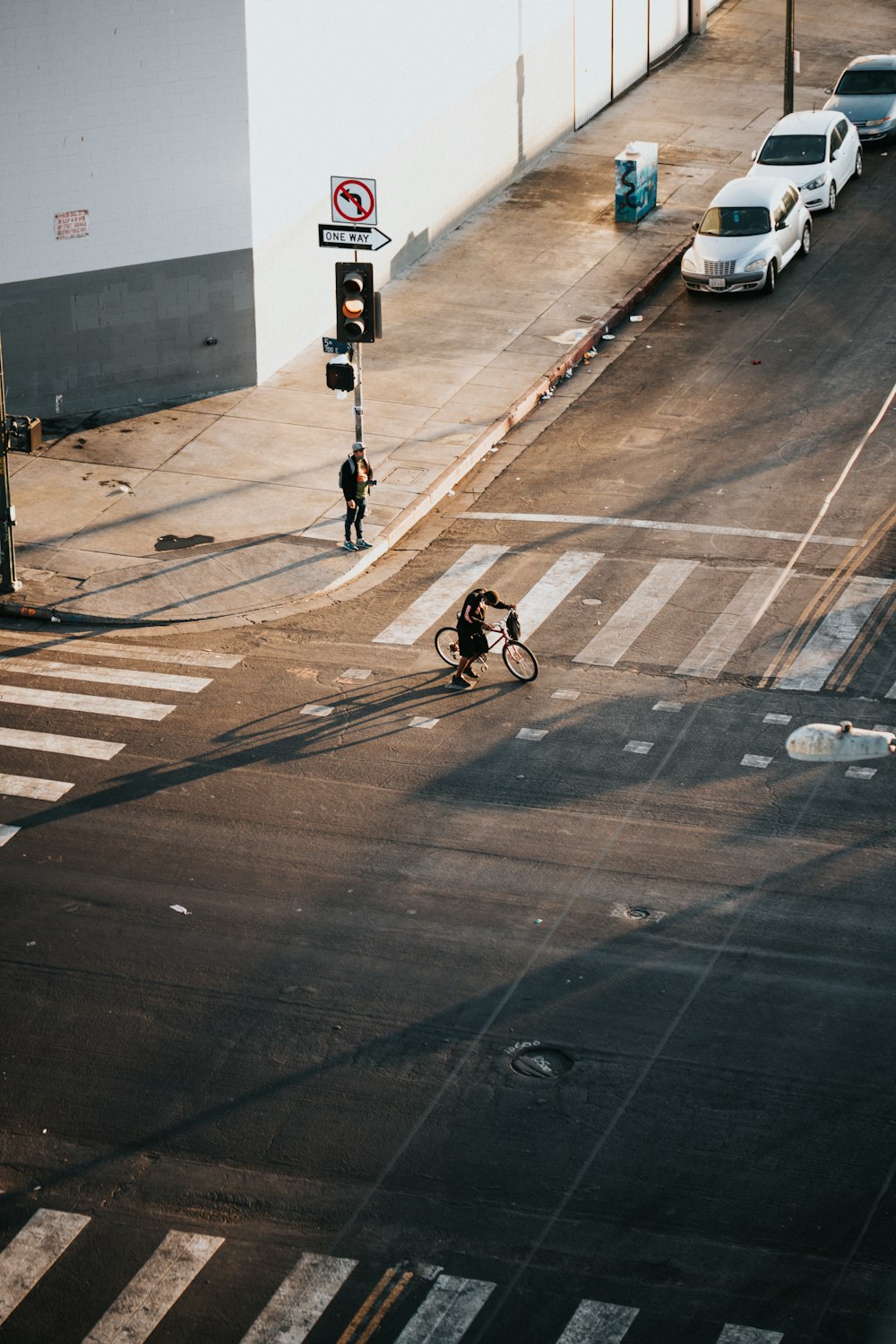 person in black jacket riding bicycle on road during daytime