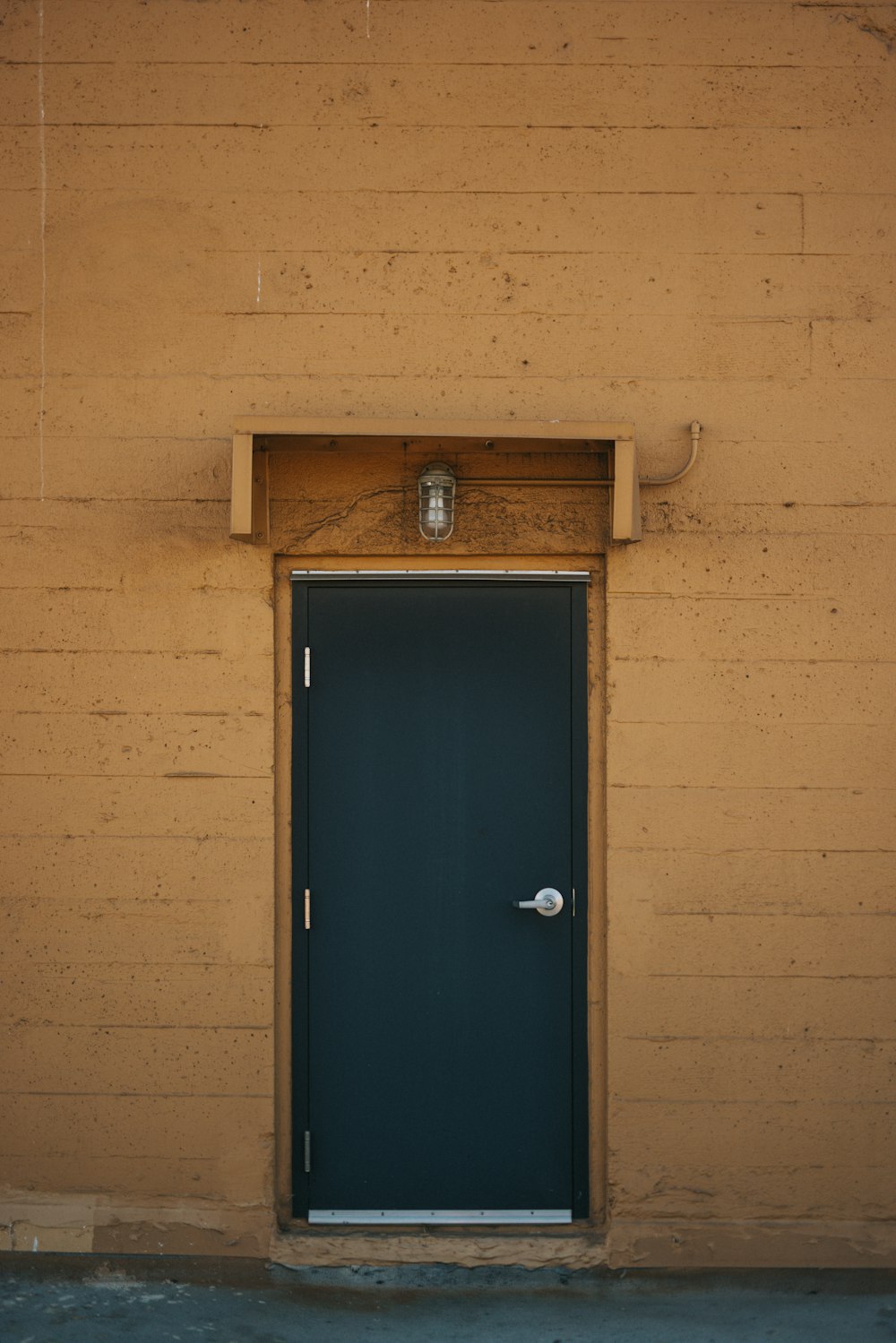 blue wooden door on brown brick wall