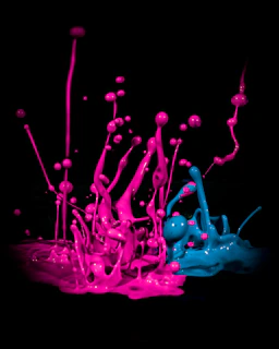 An energetic paint fight in progress, with bright droplets flying under warm studio lights