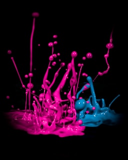 A vibrant splash of multicolored paint bursting across a dark canvas.