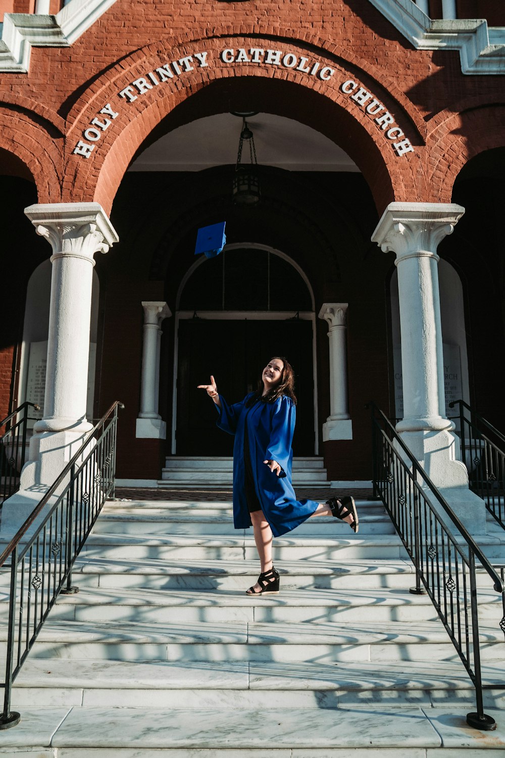 woman in blue dress walking on white concrete staircase